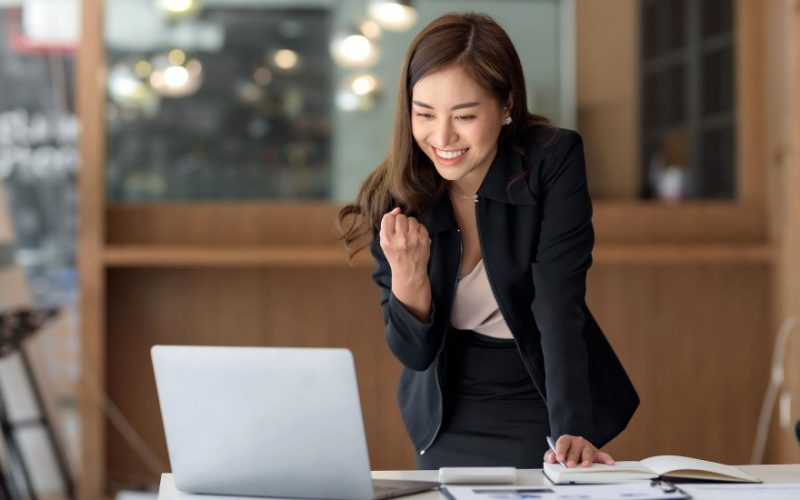 pretty-asian-businesswoman-sitting-laptop-work-came-out-successfully-goal-was-achieved-happy-satisfied-with-her